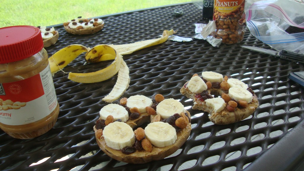 pbb&jbpr... (peanut butter and jelly bagels with sliced bananas, peanuts, and raisins... )