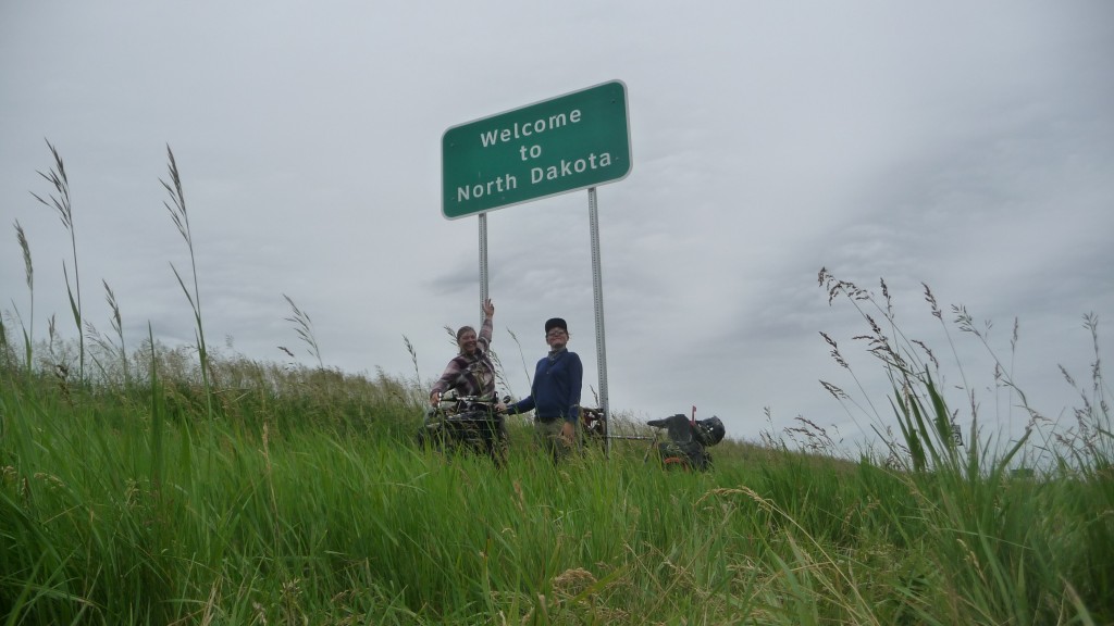 In front of the North dakota Sign