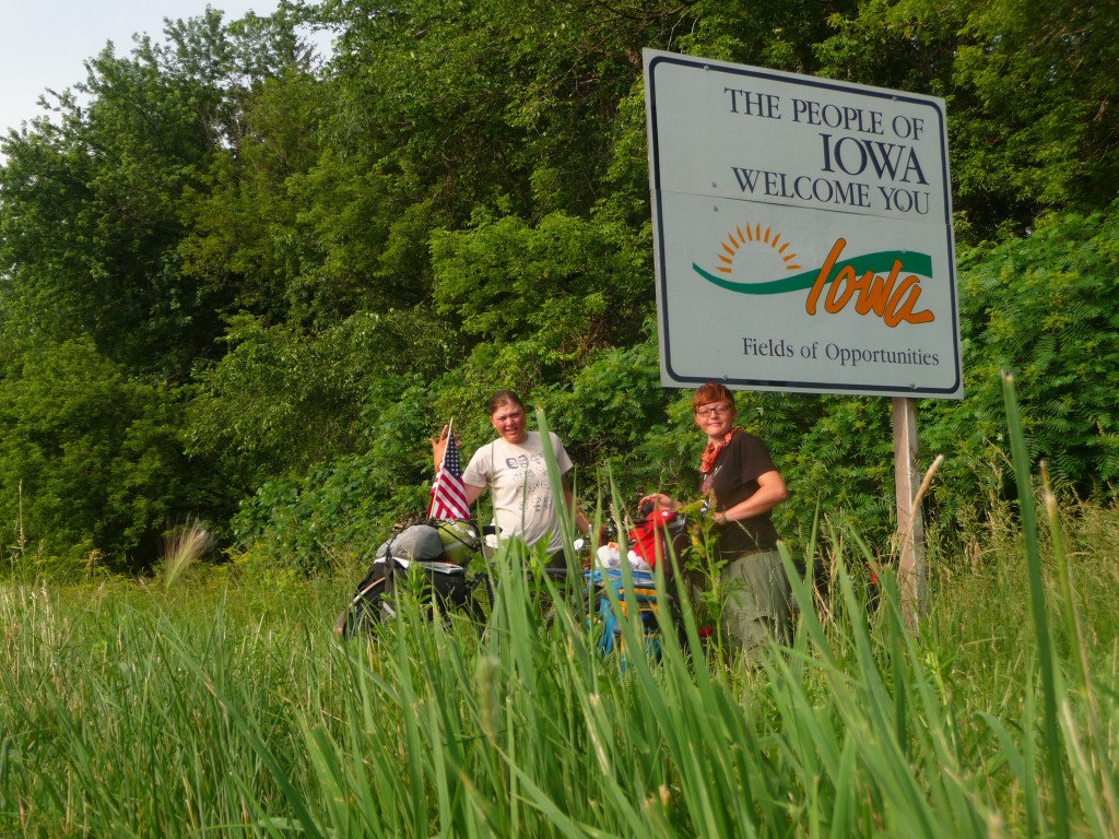 The girls in front of the Iowa sign